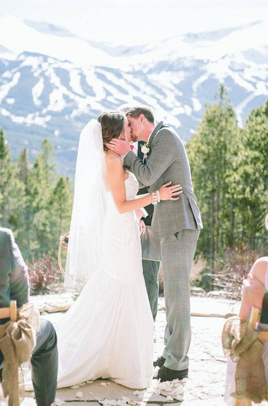 Couple kissing, snowy mountain backdrop
