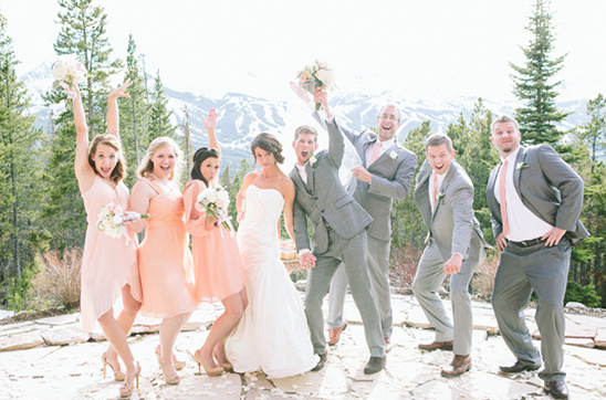 Happy wedding party poses outdoors
