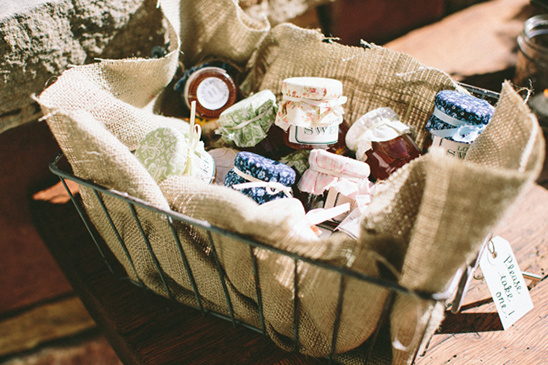 Small jars of preserves in a wire basket