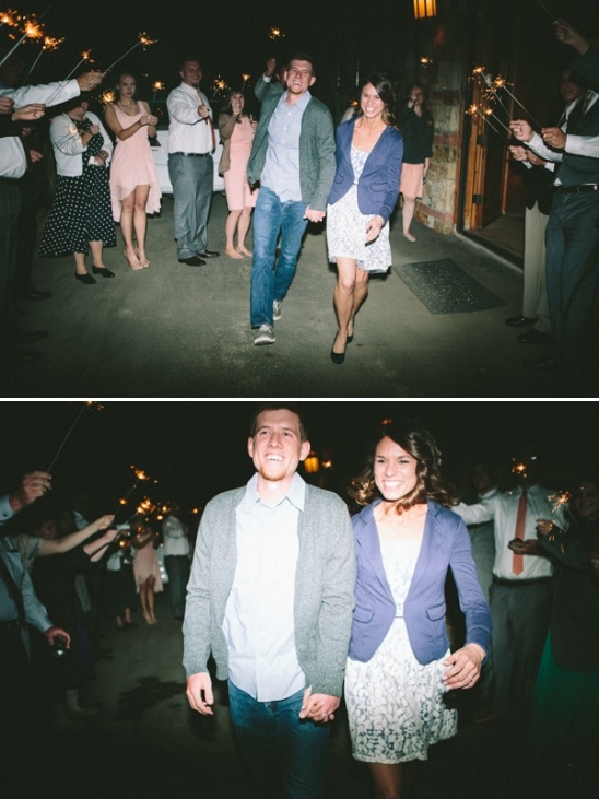 Happy couple walking away sparklers fly