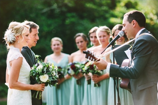 groom serenading the bride as she walks down the aisle
