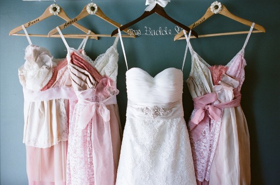 Wedding dress and bridesmaid dresses on hangers