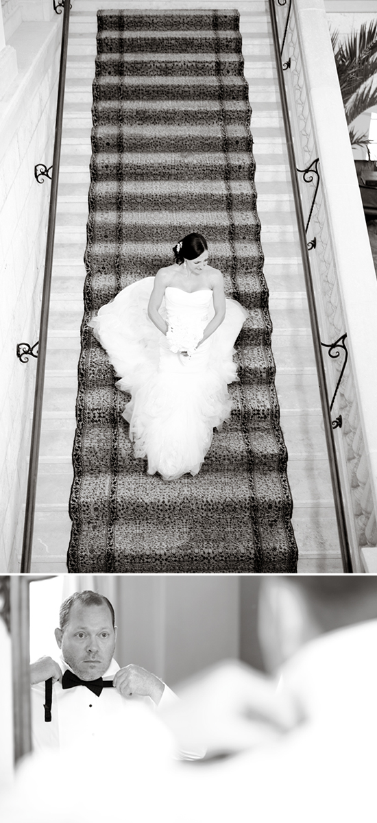 Bride on stairs and groom adjusting bowtie black and white