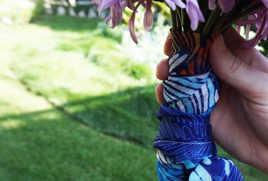 Purple flower bouquet tied with blue patterned fabric