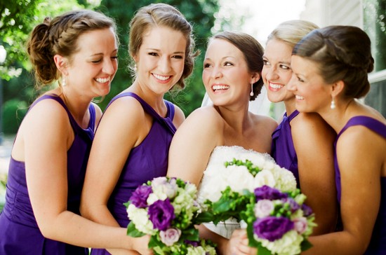Happy bridesmaids in purple dresses