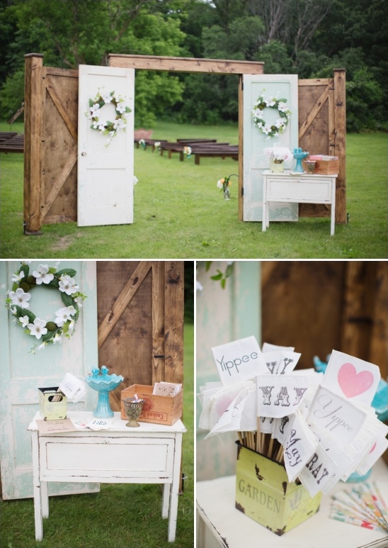 Rustic wedding decor with doors and floral wreaths