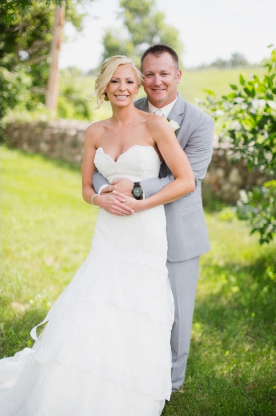 Bride and groom embrace on their wedding day outdoor