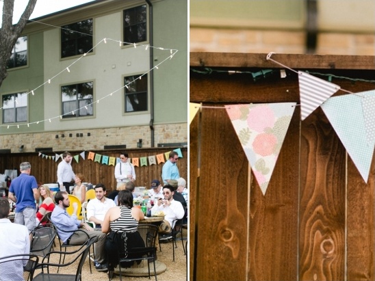 Outdoor party with colorful flags and guests