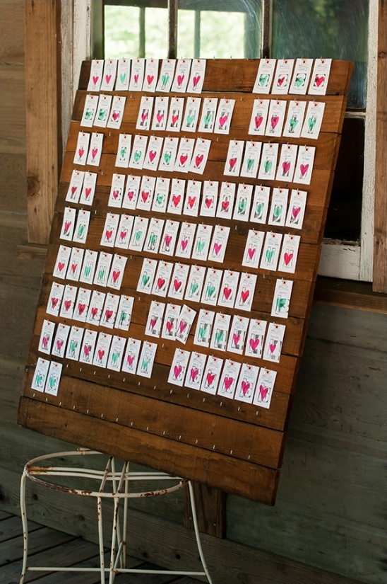 Rustic wooden seating chart with heart adorned tags