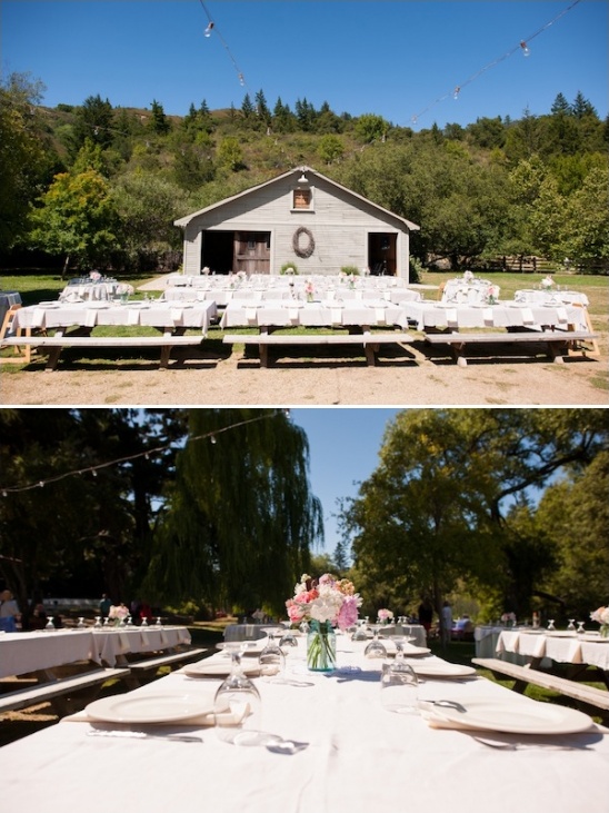 Outdoor wedding reception with long tables and barn