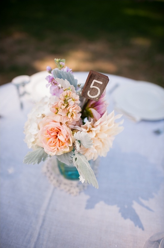 Wedding table arrangement with number five sign