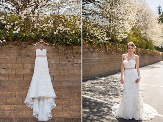 Bride and wedding dress with pink sash detail outdoors