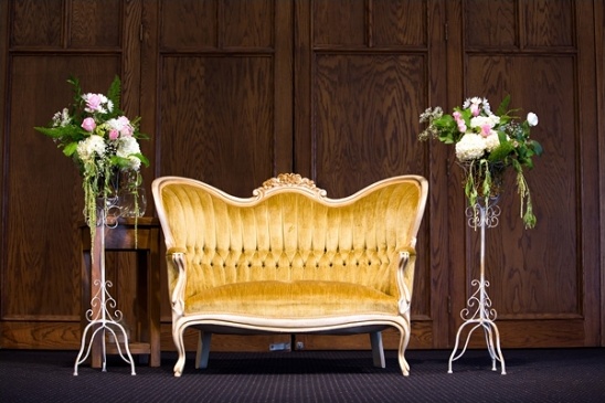 Gold vintage sofa with floral arrangements