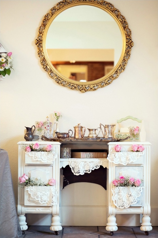 Vintage vanity with ornate mirror and lace decor
