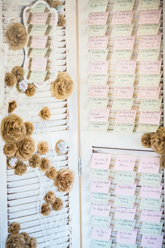 Rustic wedding seating chart on shutters with flowers