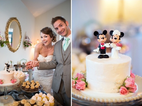Happy couple cutting wedding cake with Mickey Mouse toppers