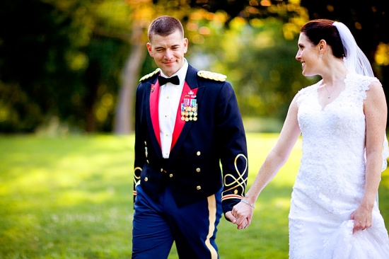 Couple in uniform and wedding dress walking
