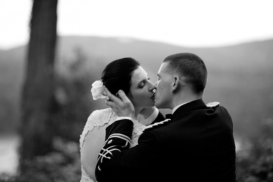 Black and white photo of a bride and groom kissing