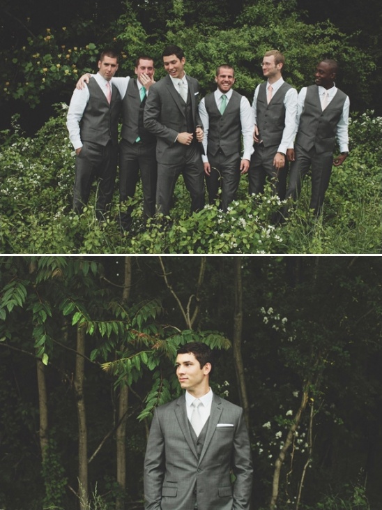 Groomsmen in gray suits pose for a photo outdoors, with a portrait shot