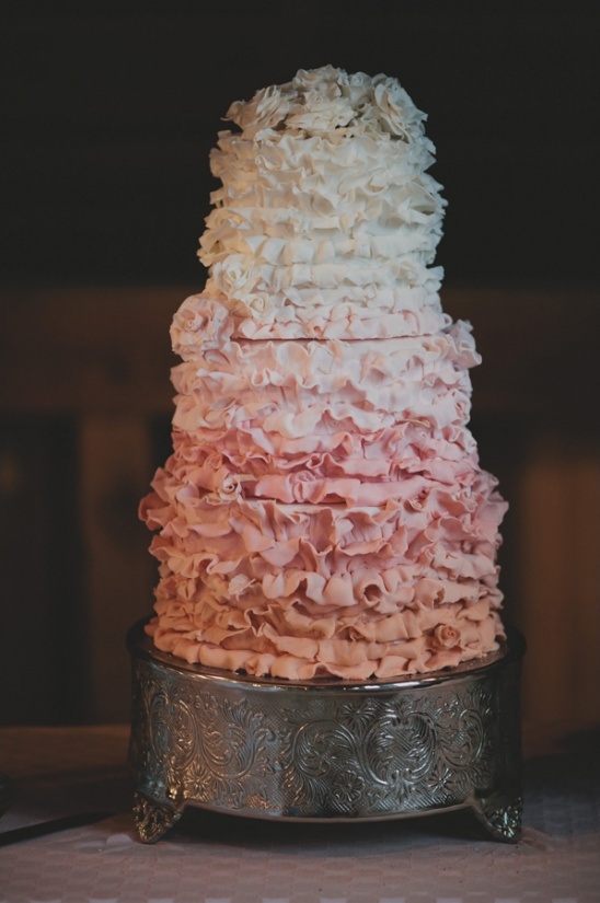 Elegant ruffled wedding cake in ombre shades of pink