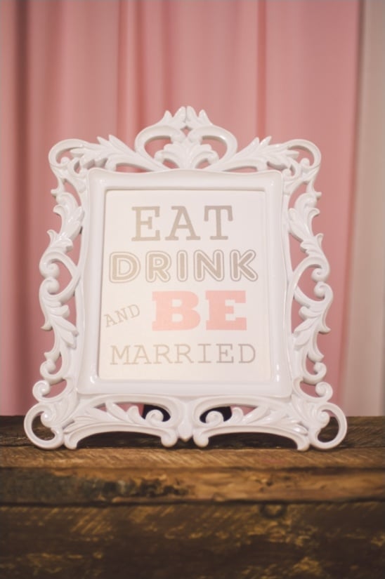 pink and white eat drink and be married sign
