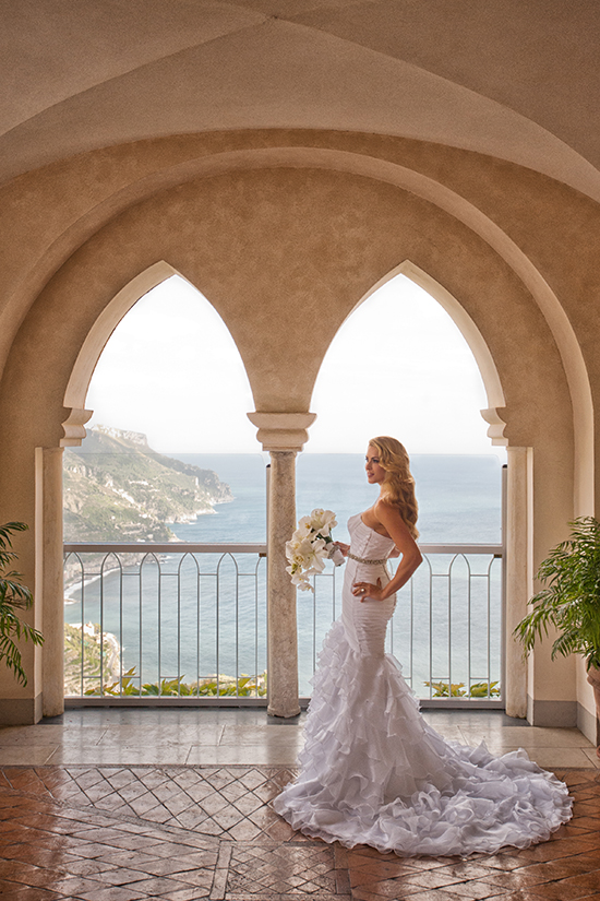 Bride in stunning wedding gown, ocean view