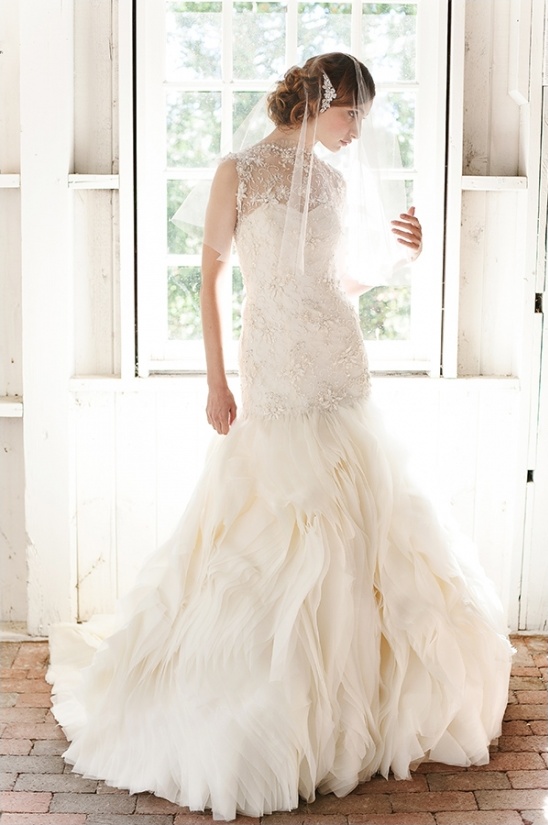 Elegant bride in a beautiful wedding dress by the window