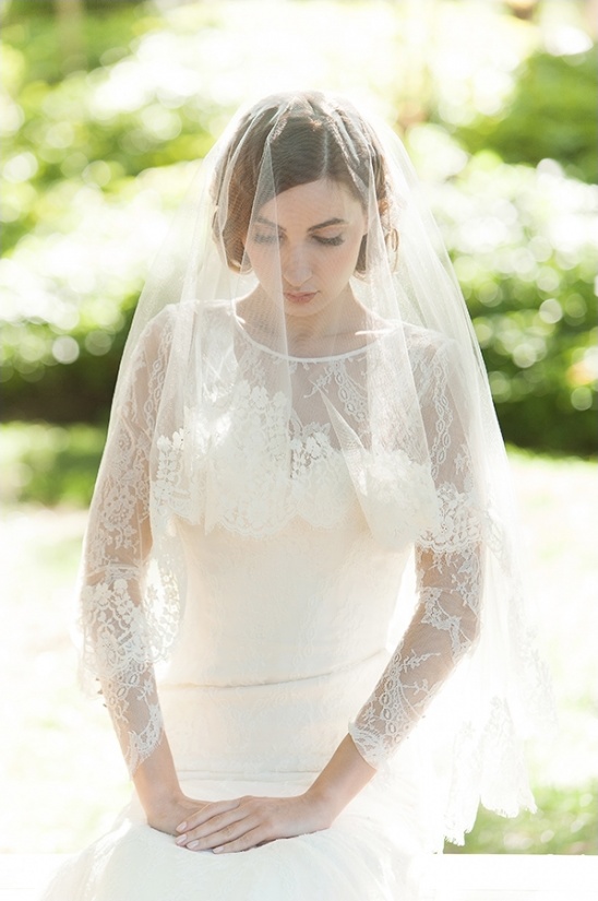 Elegant bride in a lace wedding dress and veil, posing beautifully