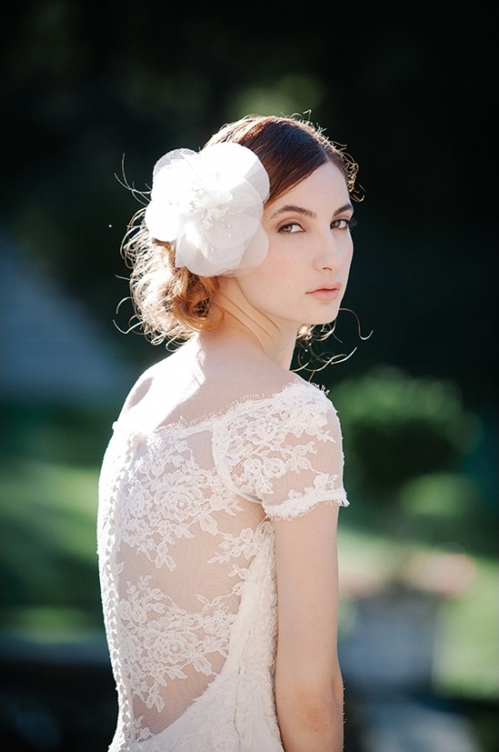 Elegant bride in lace dress with flower hair accessory
