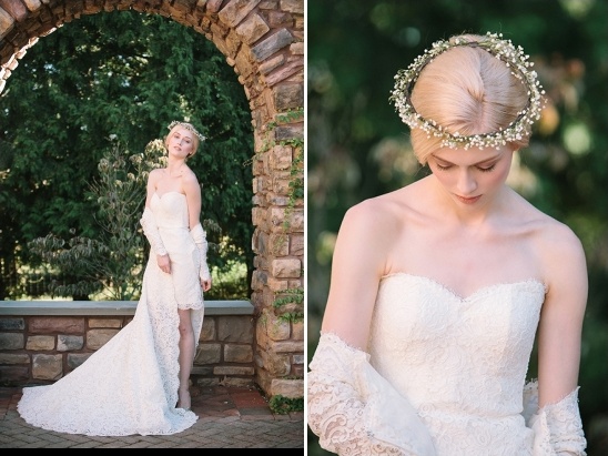 Elegant bride in a lace dress and flower crown near stone arch