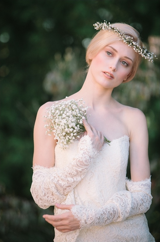 Blonde woman in a white dress with a flower crown and bouquet