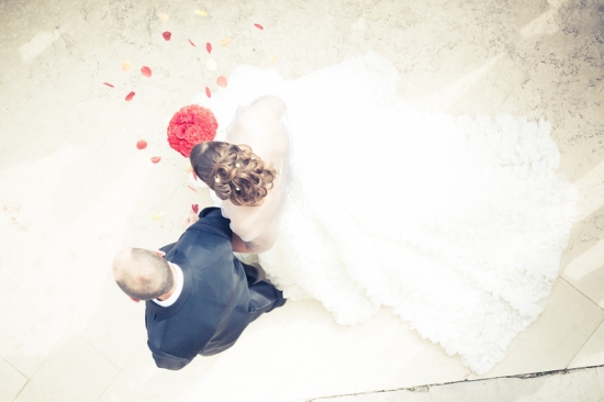 Wedding couple walking with flower petals, top view, happy moment