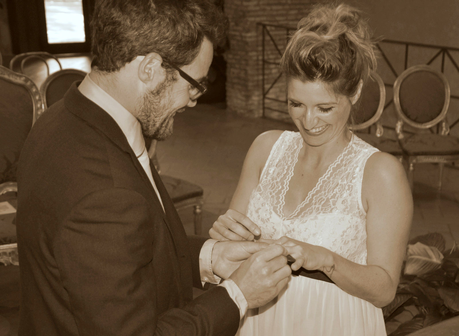 Groom places the ring on the bride's finger during the wedding ceremony