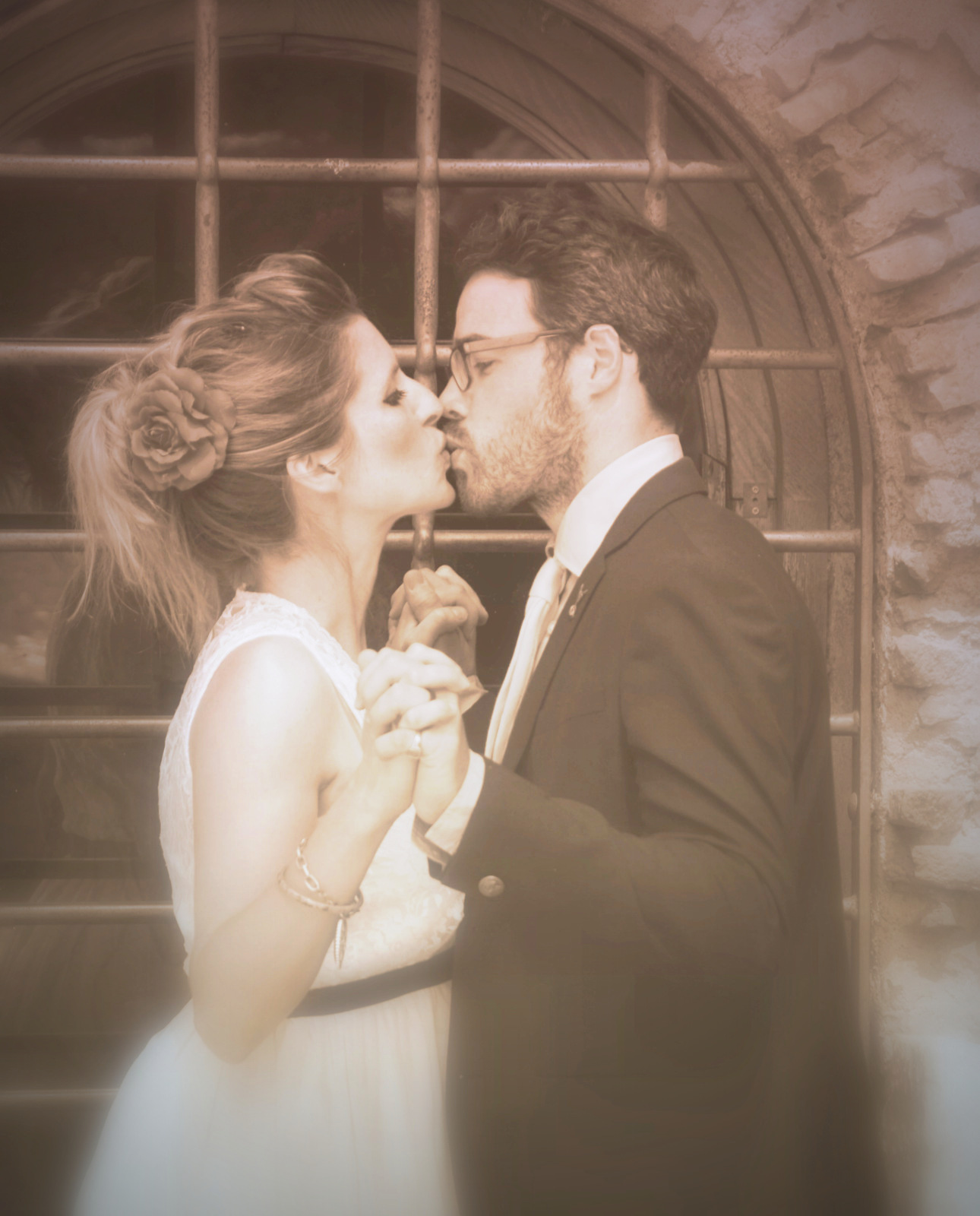 Bride and groom sharing a tender kiss on their wedding day