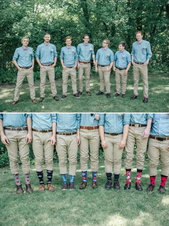 Groomsmen with matching shirts and colorful patterned socks in grass