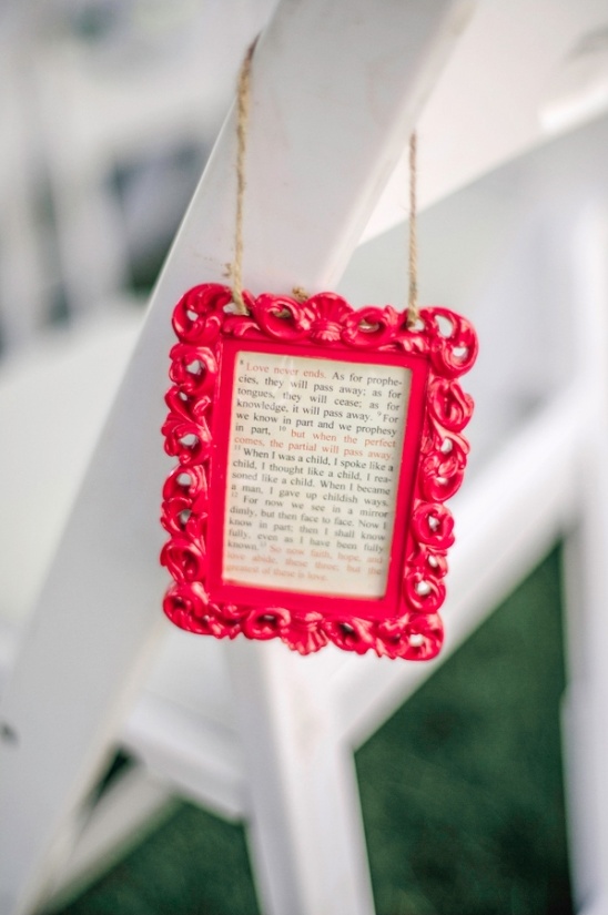 Red framed quote hanging on a chair for wedding decoration
