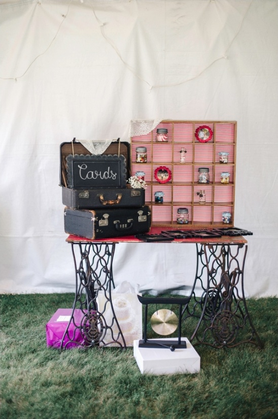 Rustic wedding card display with vintage suitcases and jars