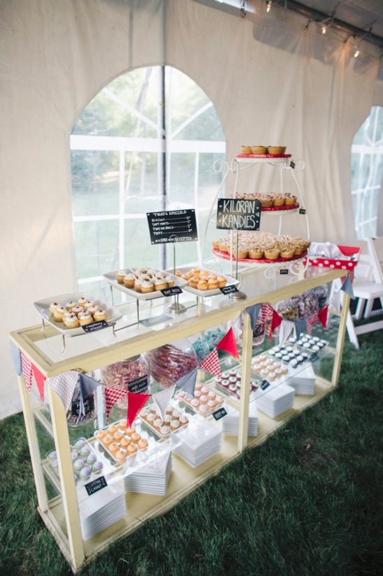 A dessert display with cupcakes and treats at an outdoor event