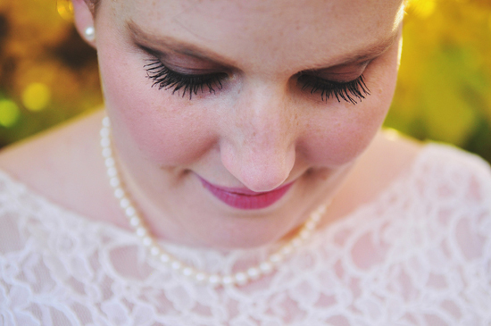Bride in lace dress, wearing pearl necklace