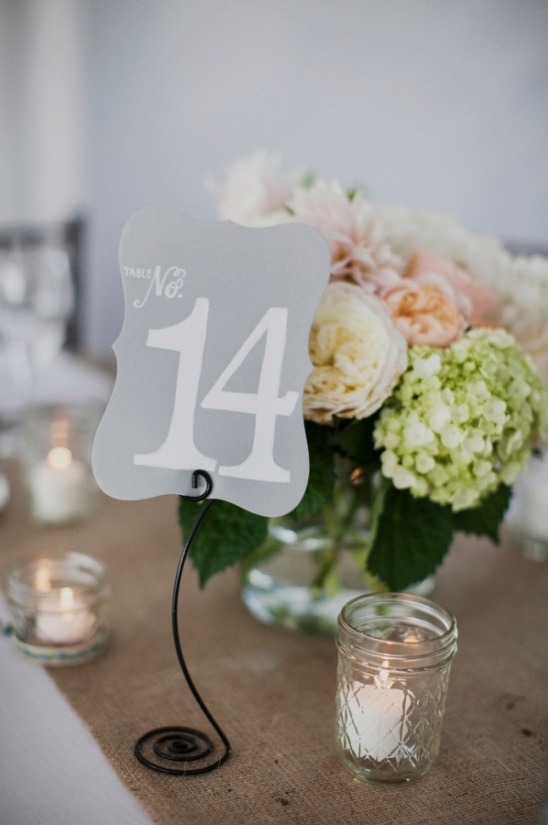 Wedding table number fourteen with flowers candles