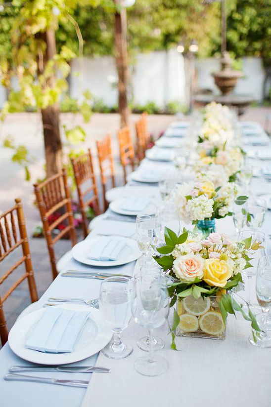 Elegant outdoor table setting with floral centerpieces