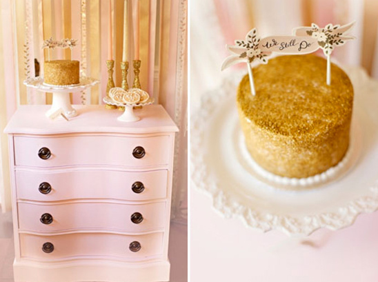 Romantic golden cake display on a pink dresser for anniversary