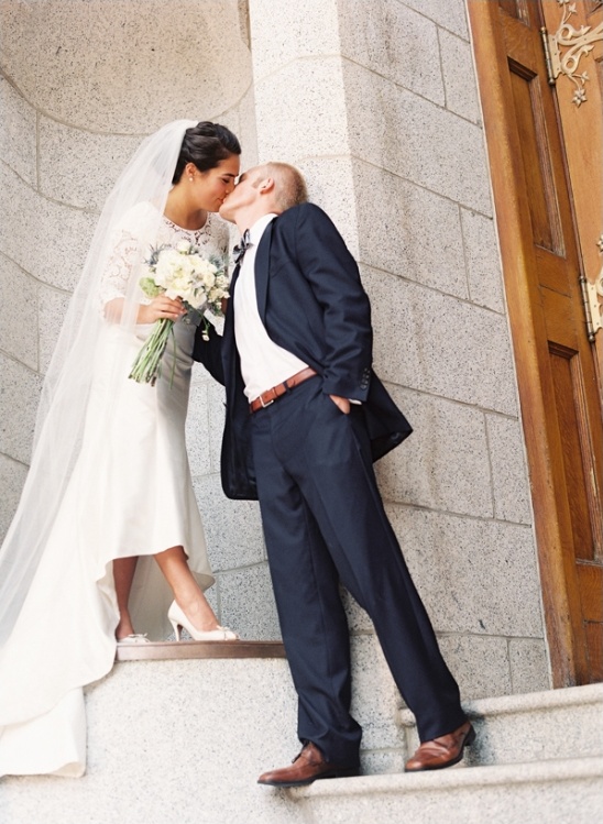 Bride and groom share a kiss after wedding ceremony