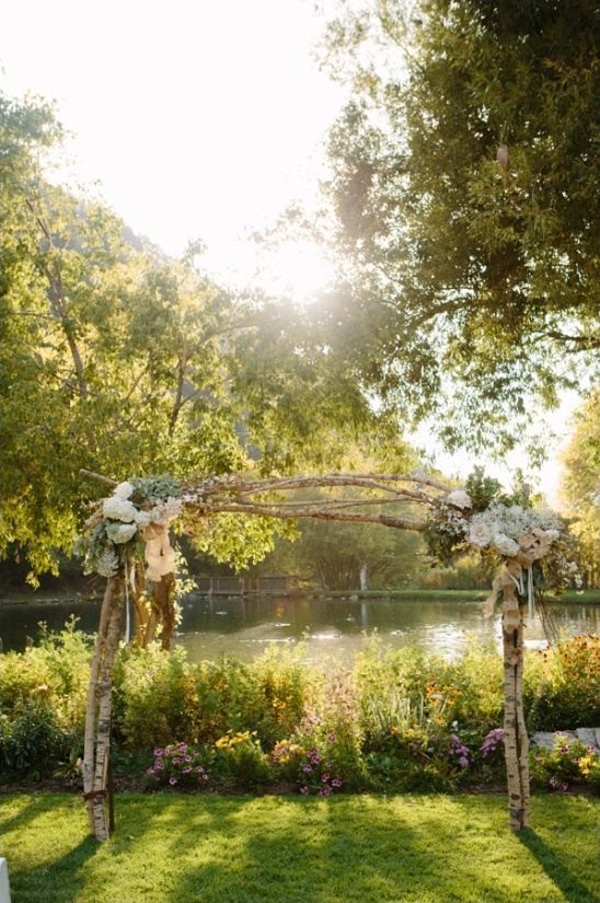 Outdoor wedding arch with floral decor in a garden