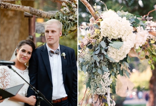 Bride and groom at outdoor wedding with floral archway