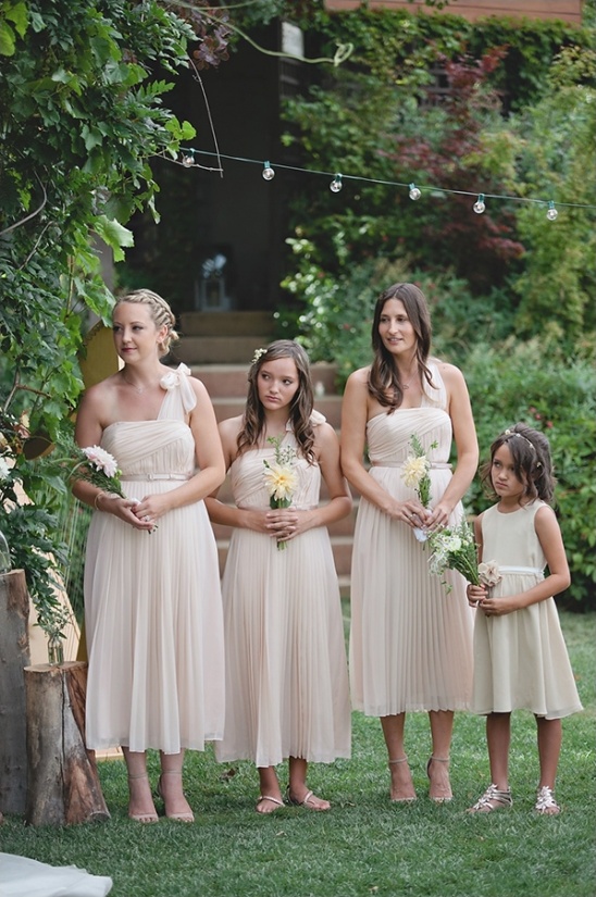 Wedding party in pastel dresses outdoors