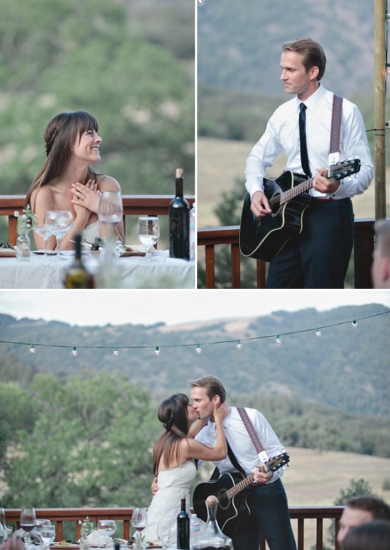 Bride watching groom play guitar at outdoor wedding