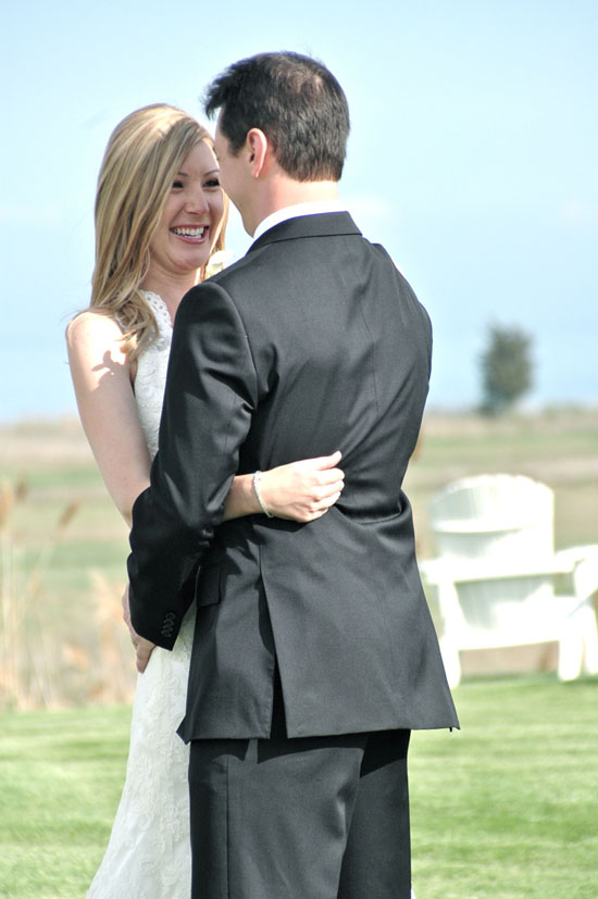 Happy bride and groom embracing outdoors
