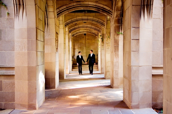 Couple walking in a stone archway