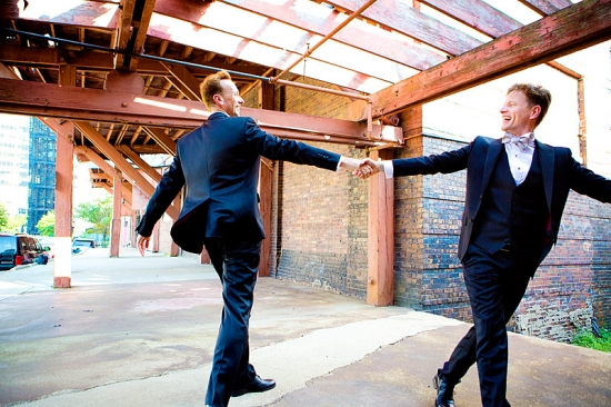 Happy couple in suits holding hands